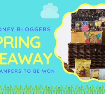 A promotional graphic for a UK Money Bloggers Spring Giveaway features a picnic hamper filled with M&S products, colorful packaging with animal faces, and text announcing SPRING GIVEAWAY, 5 M&S hampers to be won.