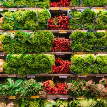 Colorful assortment of fresh vegetables arranged on supermarket shelves, perfect for healthy eating themes.